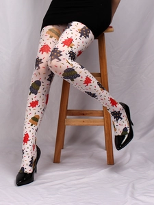 Close-up of white tights featuring colorful Christmas tree and candy cane patterns