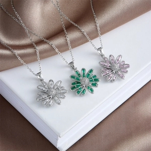 Three elegant sunflower necklaces in silver, emerald, and lavender on satin silk