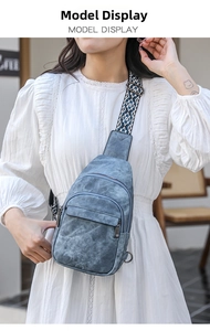 Blue vintage PU sling bag with patterned woven strap shown on model in cafe setting