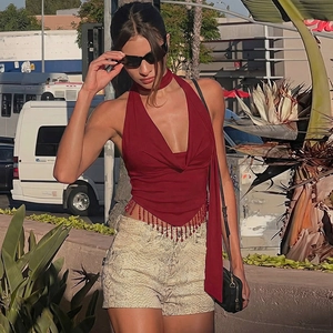 Close-up of deep red halter top featuring beaded fringe hem and pleated V-neckline detail