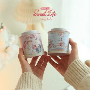 Close-up of pink and blue bunny rabbit tin boxes with Sweet Life illustrations