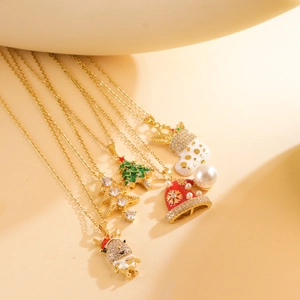Close-up of five Christmas necklaces with enamel tree, bell, reindeer and star pendants