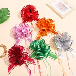 Detailed view of six colorful matte gift bows in red, orange, pink, green and silver