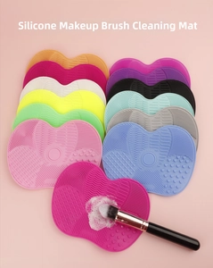 Detailed view of silicone brush cleaning mats with diverse textures and suction cups