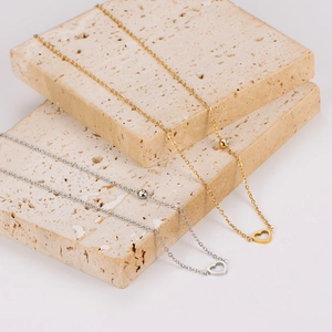 Minimalist stainless steel heart necklaces in gold and silver with round diamond pendant