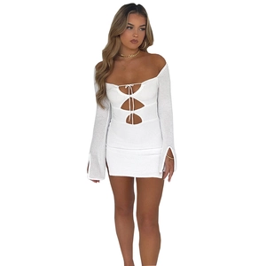 Close-up of white knitted mini dress featuring hollow-out lace-up details and honeycomb texture