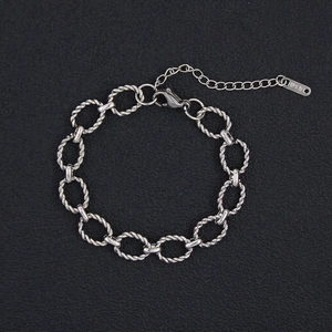 Close-up of silver titanium steel rope twist bracelet with K18 tag and lobster clasp