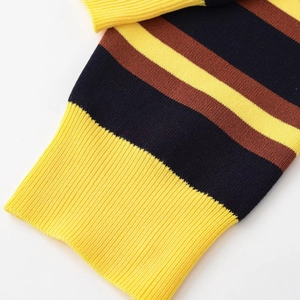 Detailed view of yellow ribbed cuff on a striped knit polo sweater for women