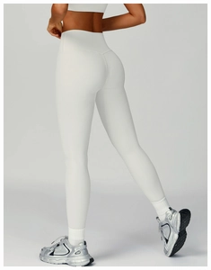 Macro shot of white ribbed high-waist yoga pants with elastic sculpting fabric details