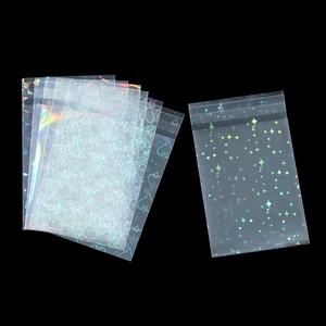Macro view of holographic laser patterns with stars and hearts on transparent seal bags