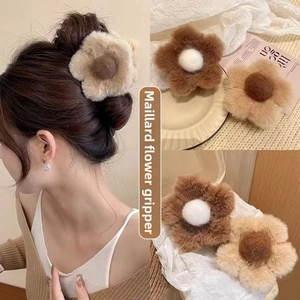 Detailed view of plush flower hair claw clips in coffee and beige colors for autumn