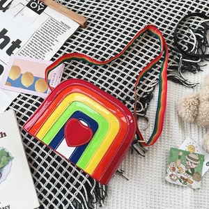 Rainbow striped crossbody bag with red heart detail and wide fabric shoulder strap