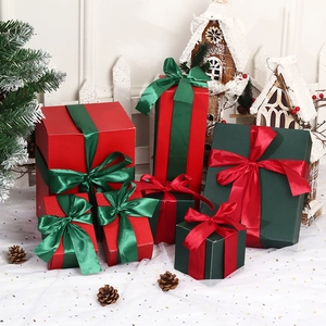 Christmas gift box set with red and green satin ribbons for festive holiday window display