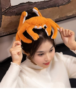 Detail of soft plush crab headband worn by model for fun party and home accessory