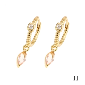 Detailed close-up of 18K gold earrings with pink marquise stones and cubic zirconia