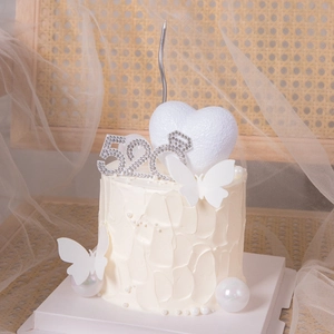 Romantic cake topper set with 520 rhinestone ring and pearls on a cream cake