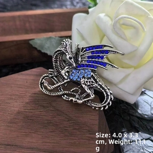 Detail showing blue rhinestone wings of a dragon brooch, 4.0x3.3cm size and 11.1g weight