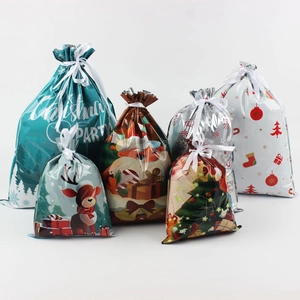 Detailed view of assorted Christmas drawstring gift bags with Santa and reindeer prints