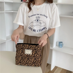 Detail of leopard print canvas pouch with zipper and Pleasant Time vintage label