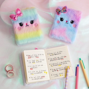 Detail of plush cat diary featuring soft faux fur cover and colorful sequin bow accents