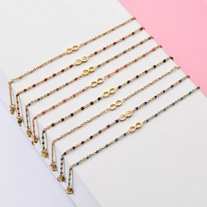 Set of 8 bohemian infinity bracelets in gold finish with colorful assorted beads