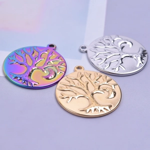 Close-up of tree of life pendants in iridescent, gold, and silver stainless steel finishes
