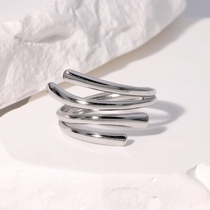 Macro shot of silver multi-layer spiral ring with minimalist metallic finish on stone
