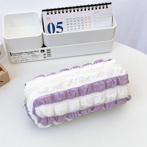 Detail of pleated lilac striped pencil case showing soft fabric texture and zipper closure