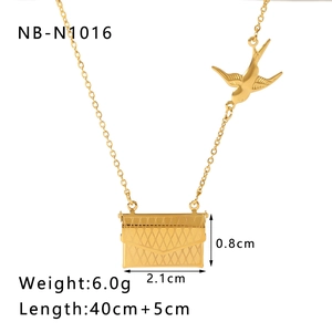 Detailed view of golden swallow and envelope pendant with size and weight specifications