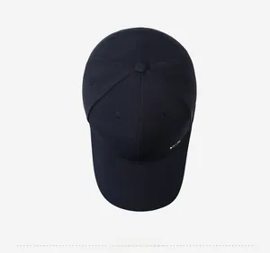 Top view of navy blue baseball cap showing six-panel crown and metal logo plate detail