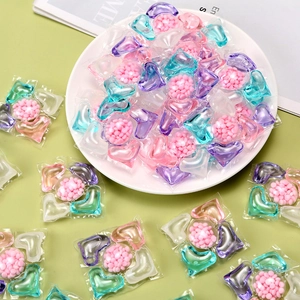 Five-in-one flower-shaped laundry pods with colorful gel chambers on a white plate