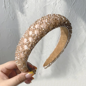 Detail of champagne satin headband featuring hand-beaded rhombus grid pattern design