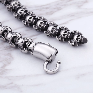 Macro detail of punk skull link bracelet with vintage stainless steel hook clasp closure