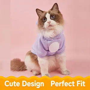 Soft purple pet hoodie with hood and white patch shown on a cat against pink background