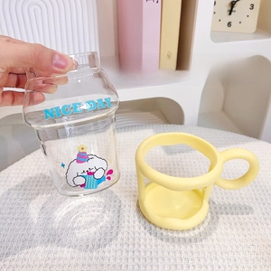 Detail showing detachable base and glass cup body with cute dog and NICE DAY print
