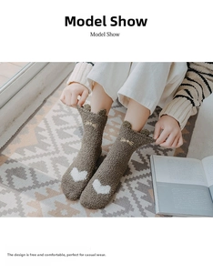 Close-up of thick brown coral fleece socks with white heart patterns and 3D animal ears