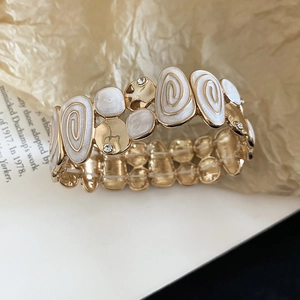 Detailed macro of vintage stretch bracelet with white enamel texture and crystals