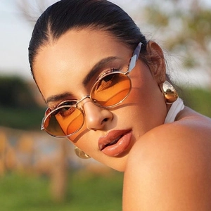 Retro oval sunglasses for women with orange gradient lenses and slim metal temples