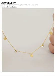 Detailed view of a gold heart and zircon pendant necklace on a clean white surface