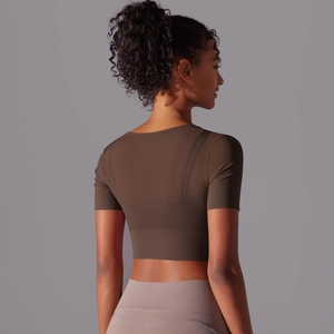 Detail of crop top back featuring breathable mesh splicing and high-stretch fabric