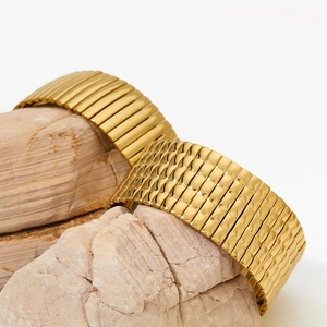 Golden stretch stainless steel bangles with striped texture on natural pink stone