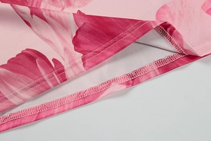 Close-up of pink floral dress hem showing high-quality stitching and overlock detail