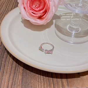 Detailed macro view of butterfly ring with pink heart zircon and silver finish