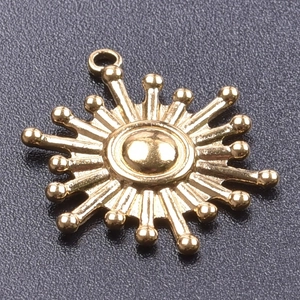 Detailed macro view of a 18k gold plated stainless steel sunburst pendant charm