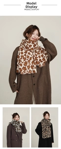 Close-up of leopard print scarf with soft tassels and detailed floral pattern mix