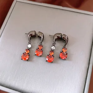 Zircon water drop earrings in gunmetal finish with bright orange stones and S925 needles