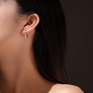 Elegant gold S925 sterling silver hoop earrings with pavé crystals on a model