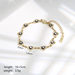 Detail view of gold heart chain links with evil eye motifs and dimension specifications