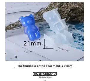Detail showing 21mm thick silicone mold and resin bear figurine on a decorative surface