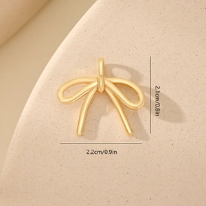 Detailed size view of a golden bow pendant with zircons, measuring 2.2cm by 2.1cm